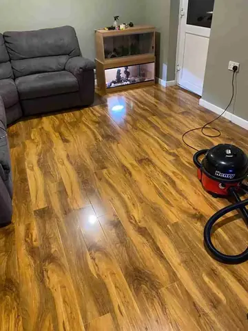 A living room with newly laid glossy wood-effect laminate flooring